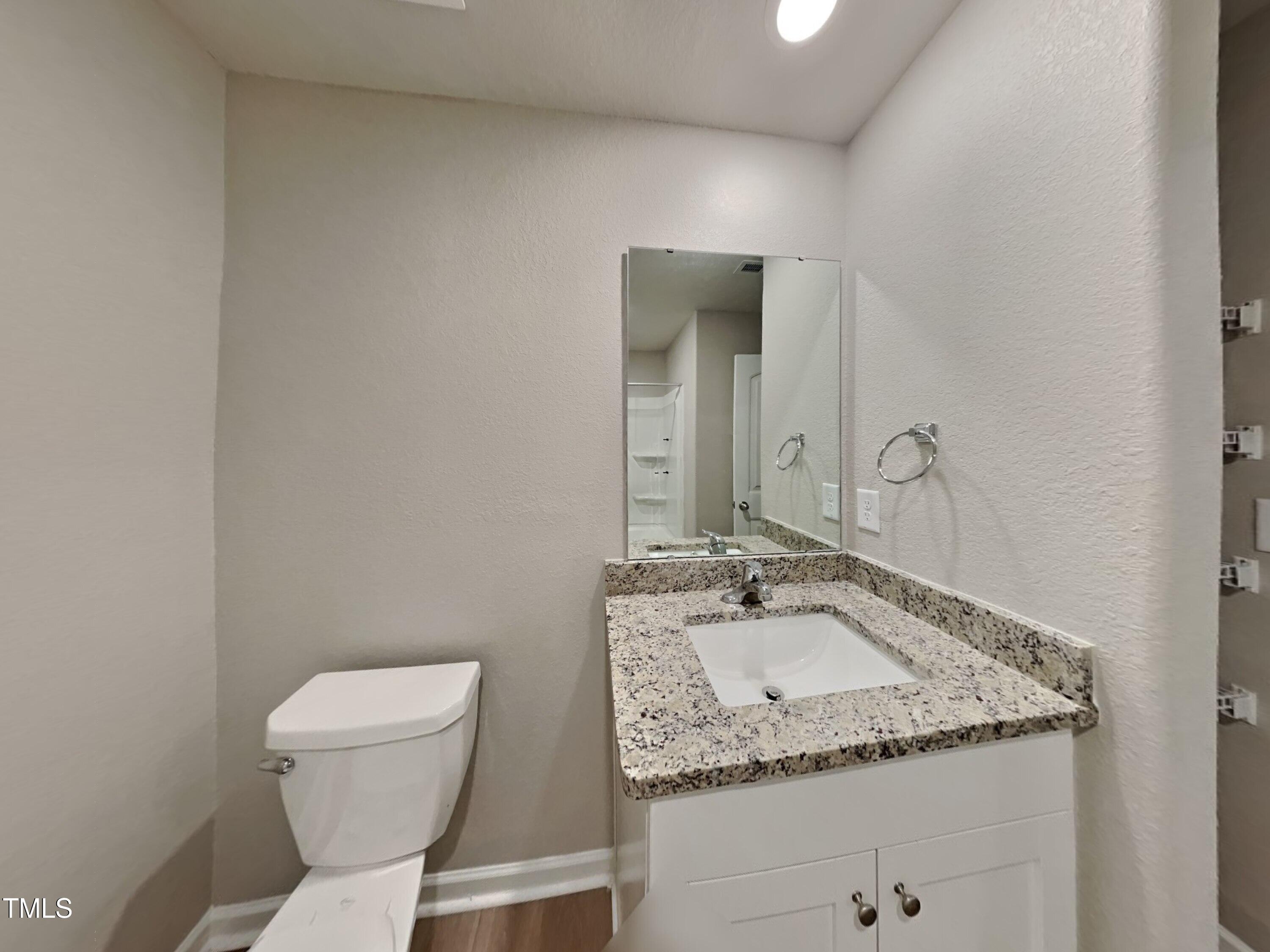 342 Coleshill Road Angier, NC 27501 - Photo 13 of 15 a bathroom with a granite countertop toilet sink and mirror