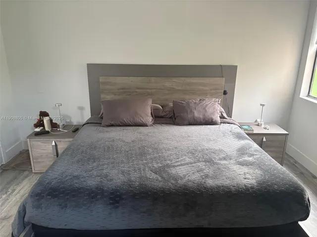 a bedroom with a bed and a potted plant