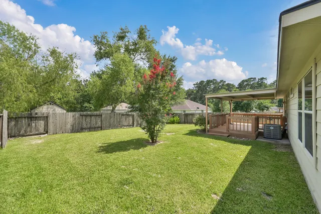 a view of a deck with a big yard