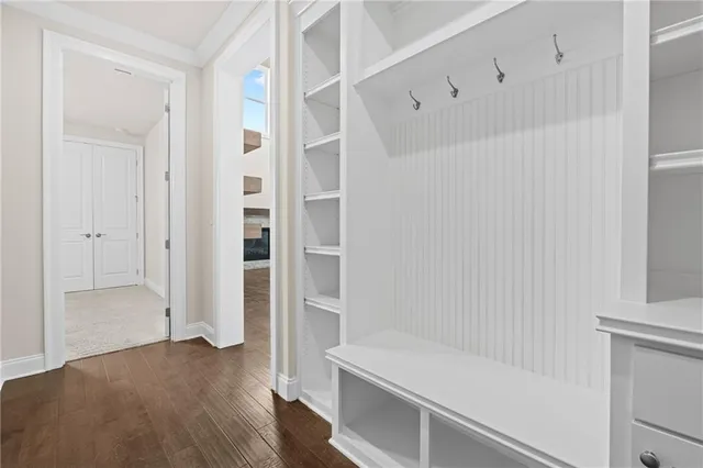 a view of an empty room with a window and kitchen view