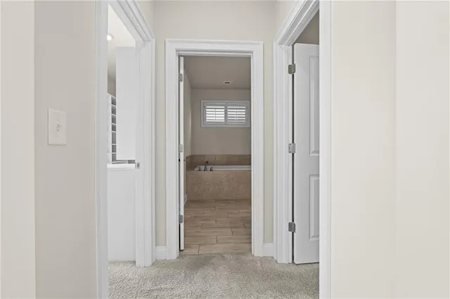a view of a hallway with wooden floor and stairs
