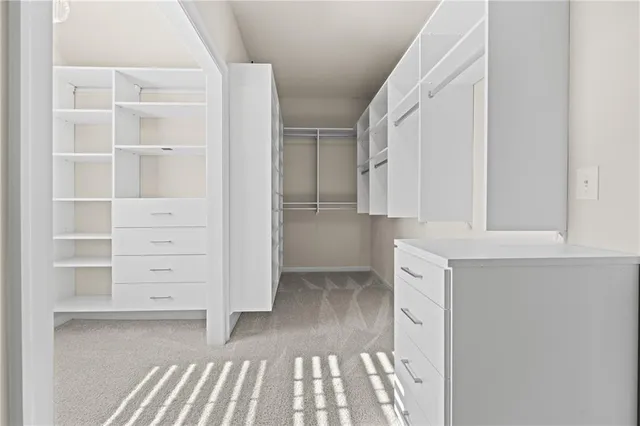 a bathroom with a granite countertop toilet sink mirror and vanity