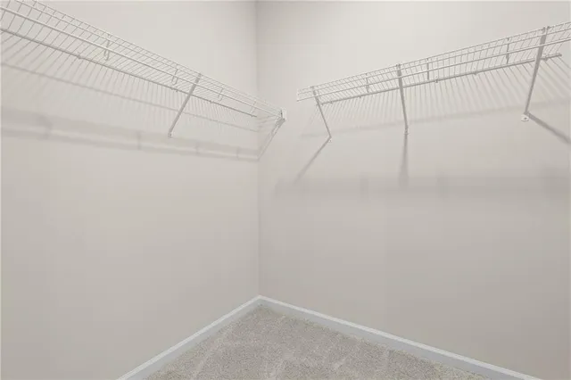 an empty room with a window and a mirror