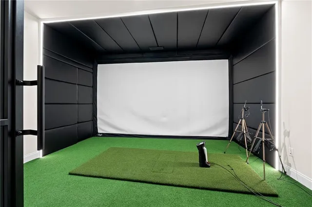 a view of a white house with a small yard and large tree