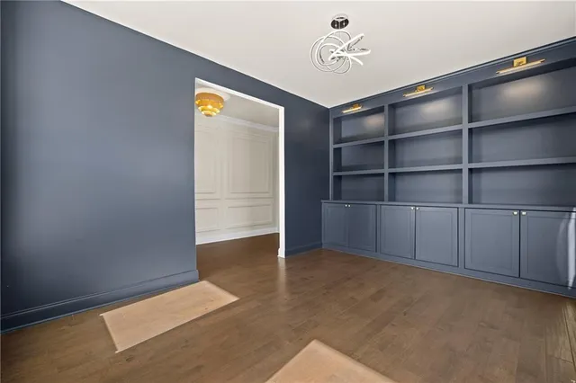 a kitchen with stainless steel appliances granite countertop a lot of counter space and wooden floors