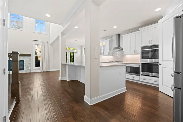 a kitchen with stainless steel appliances granite countertop a refrigerator a sink and a stove