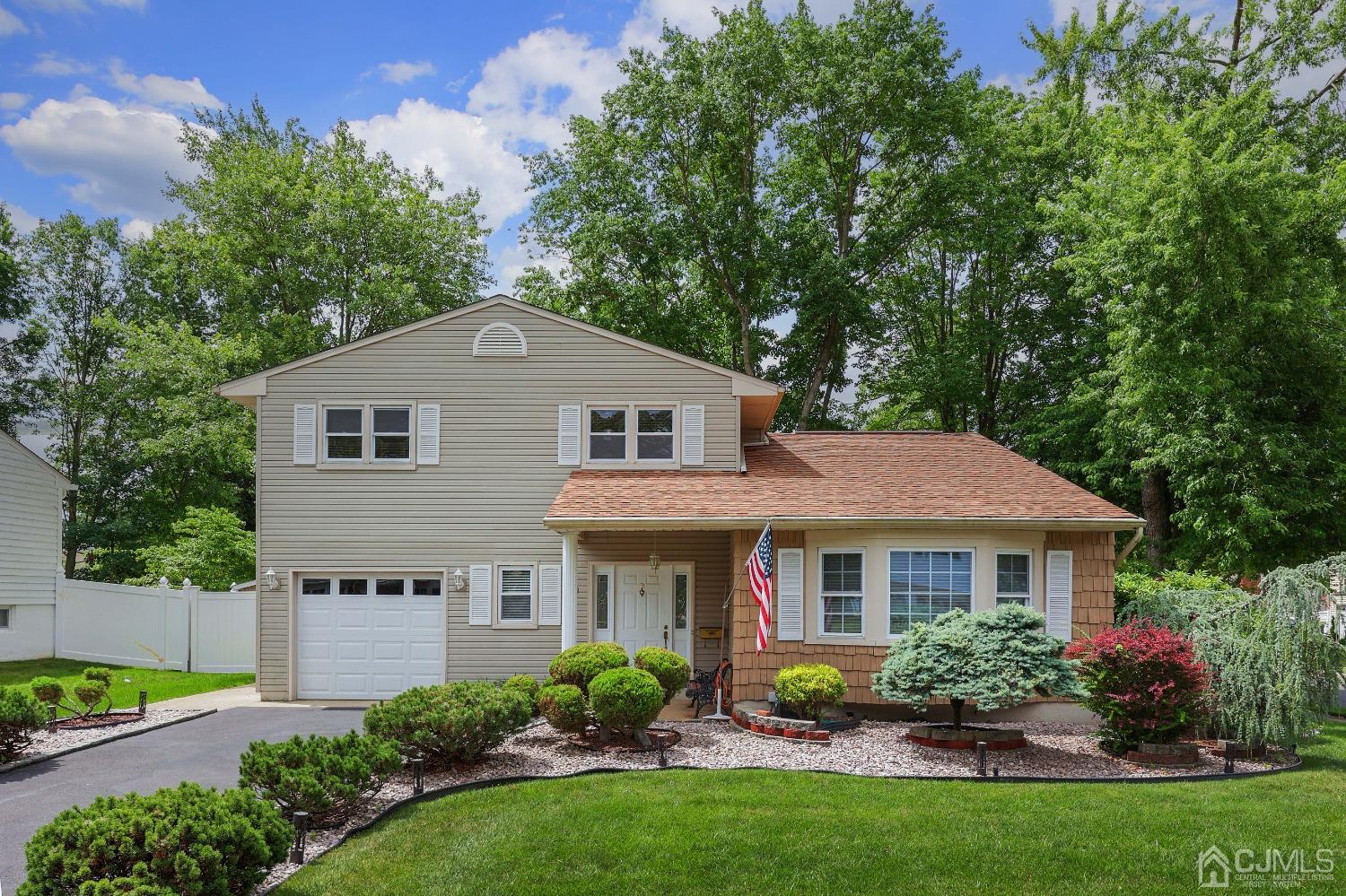 10 Gramercy Road Old Bridge, NJ 08857 - Photo 1 of 31 a front view of a house with a garden and plants