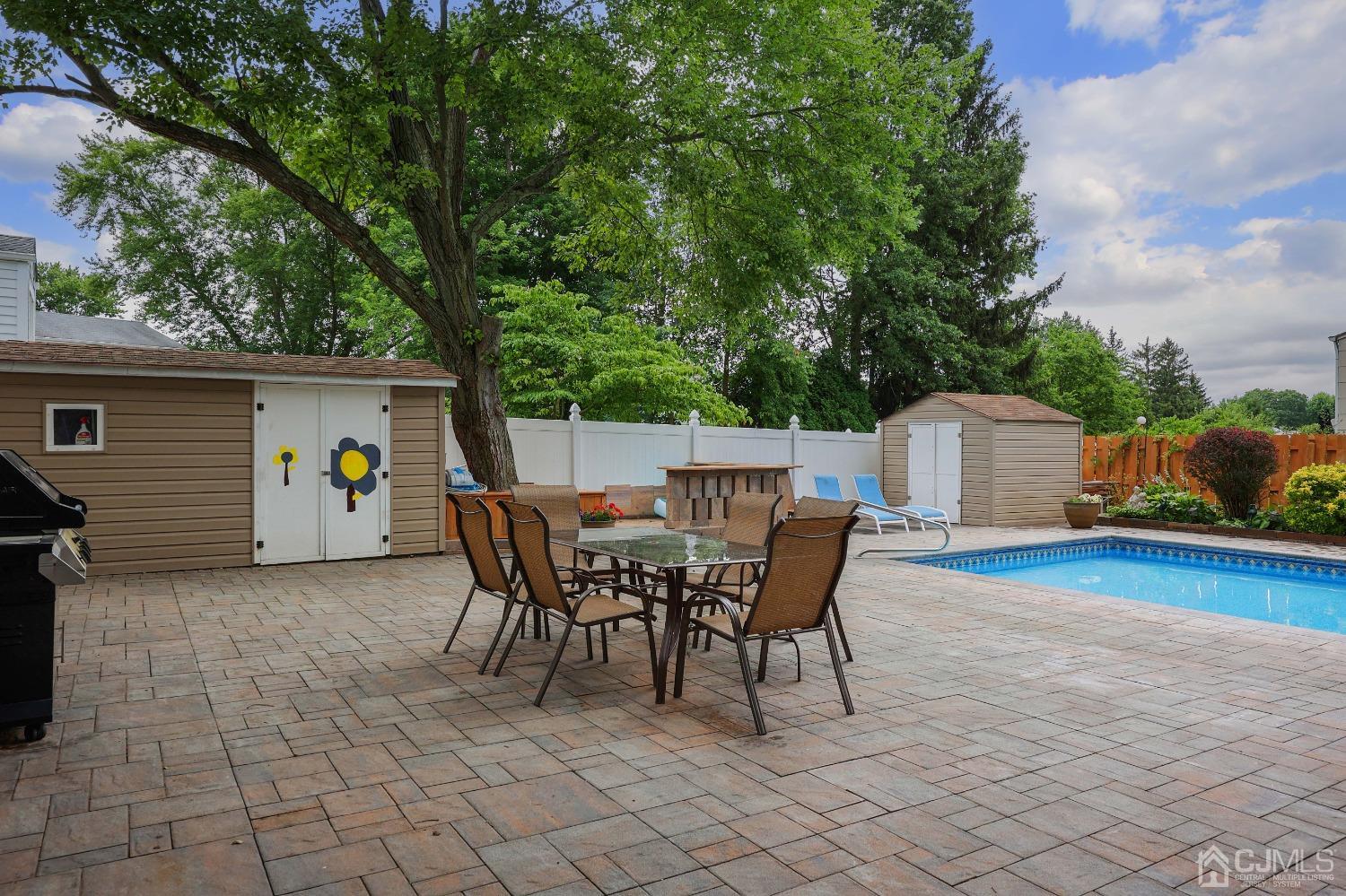 10 Gramercy Road Old Bridge, NJ 08857 - Photo 31 of 31 a view of a patio with dining table and chairs with wooden fence and plants