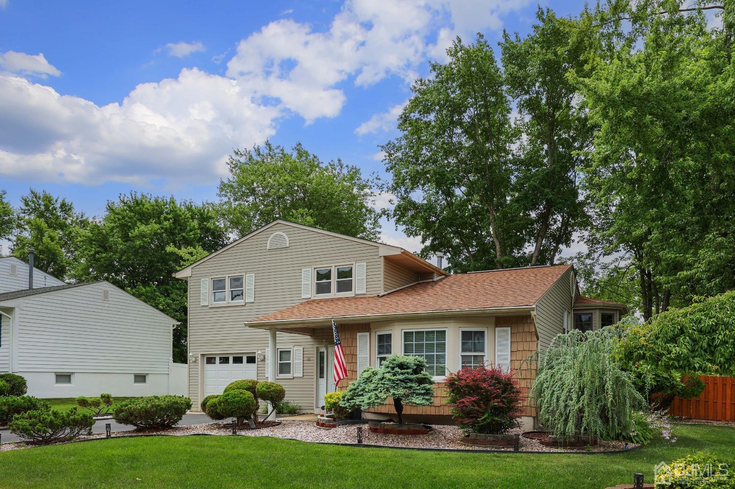 10 Gramercy Road Old Bridge, NJ 08857 - Photo 5 of 31 a front view of a house with garden and trees