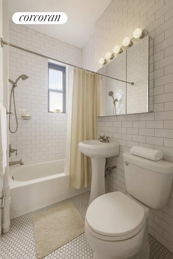 21-67 33rd Street, Unit 5E Queens, NY 11105 - Photo 3 of 4 a bathroom with a toilet a sink and bathtub
