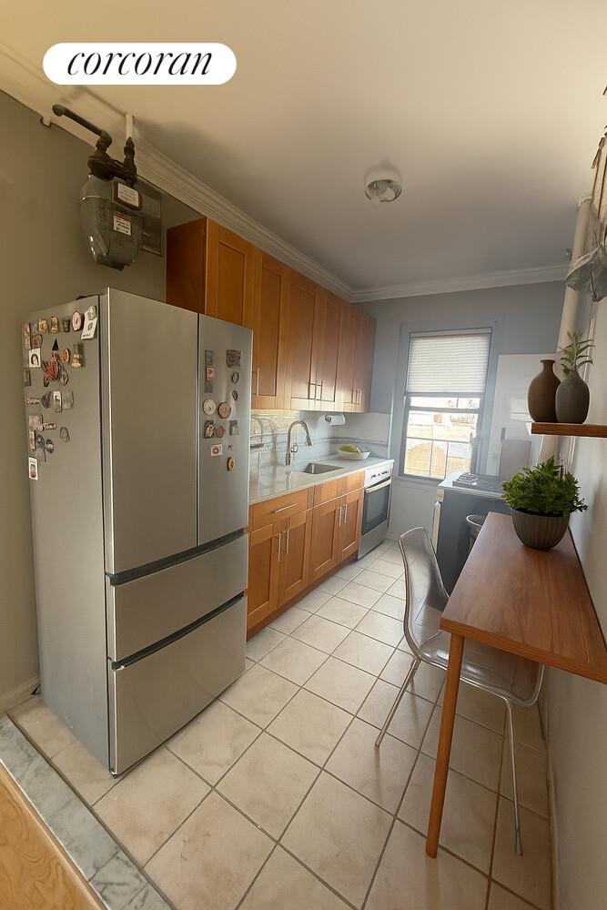 21-67 33rd Street, Unit 5E Queens, NY 11105 - Photo 4 of 4 a kitchen with refrigerator and window