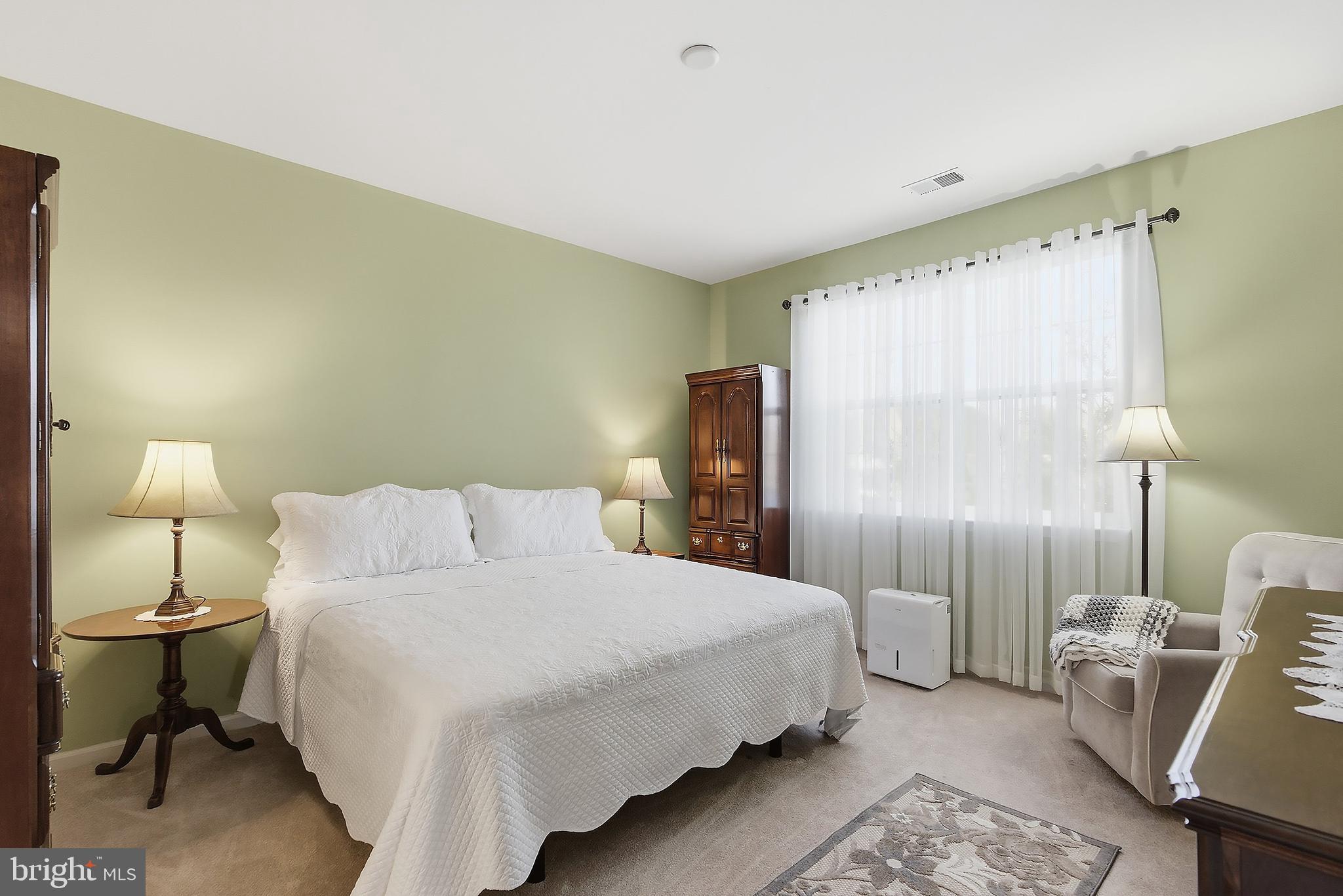 16 Raccoon Lane Barnegat, NJ 08005 - Photo 16 of 31 a bedroom with a bed wooden floor and a lamp