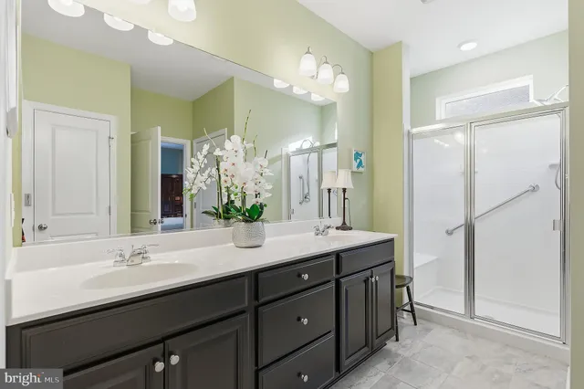 a bathroom with a double vanity sink mirror and double