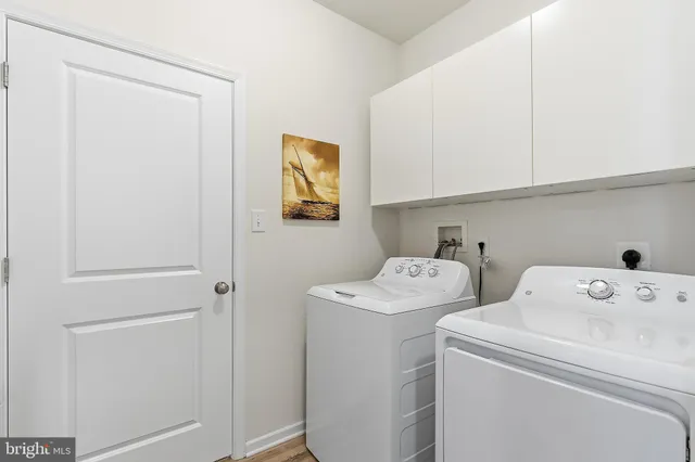 a view of storage and utility room with washer and dryer