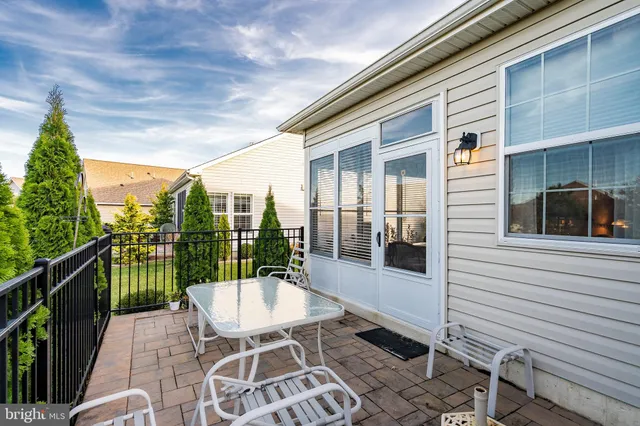 a view of a patio with a table and chairs