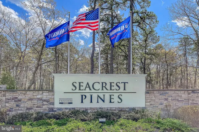 a view of a street sign under a large tree