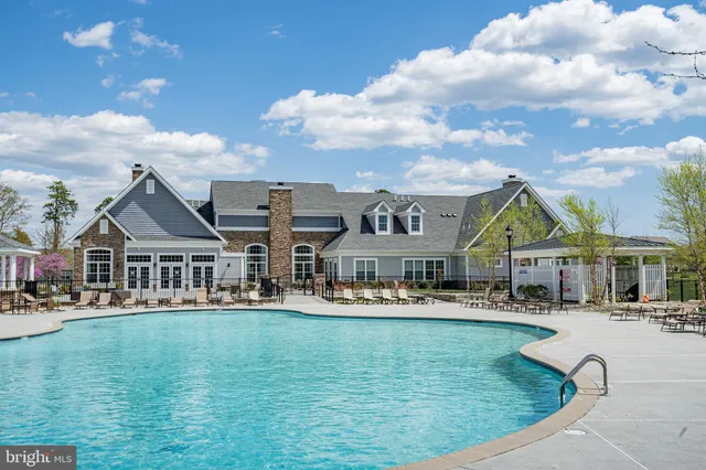 a swimming pool view with a garden and plants