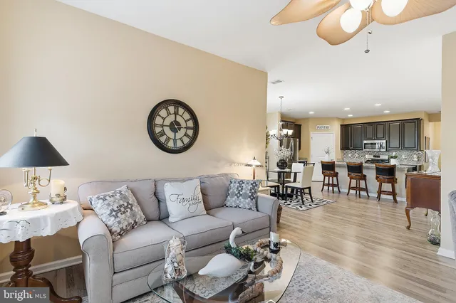 a living room with furniture a rug and a wall painting