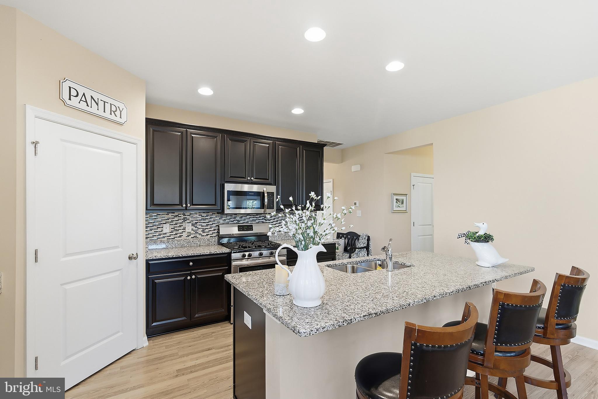 16 Raccoon Lane Barnegat, NJ 08005 - Photo 10 of 31 a kitchen with kitchen island granite countertop a sink and refrigerator