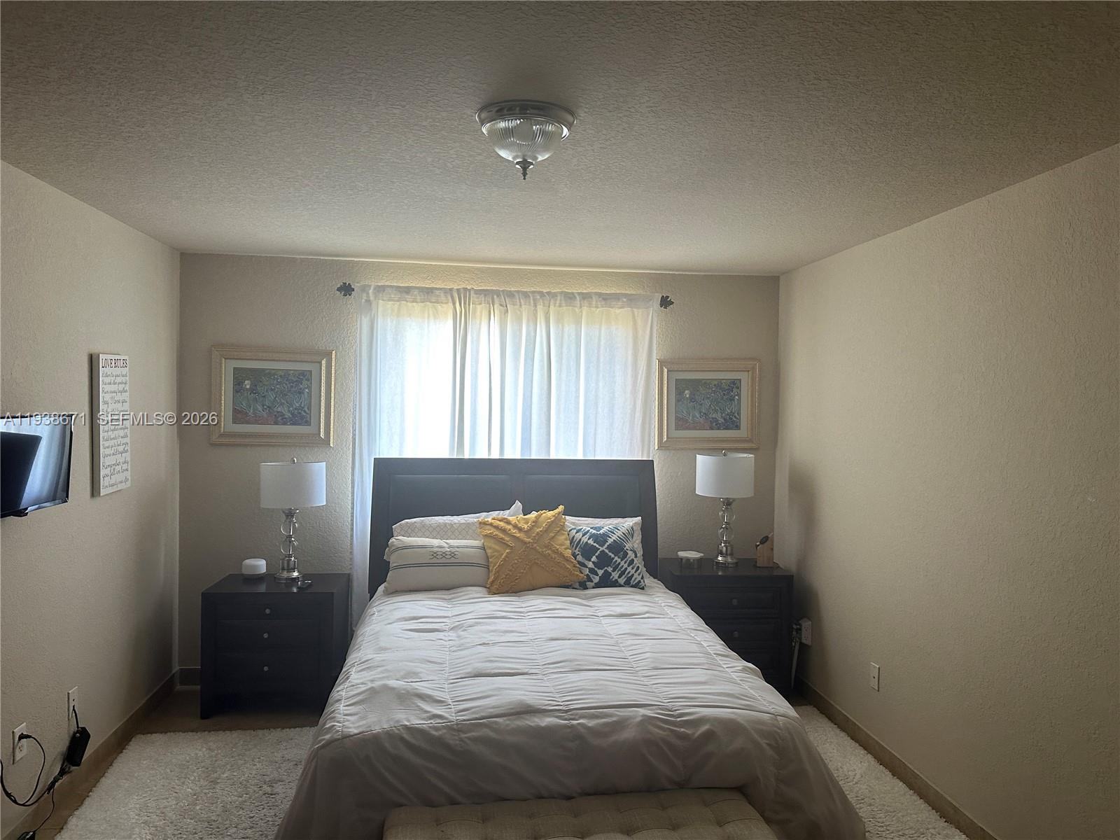 5954 Royal Way Tamarac, FL 33321 - Photo 17 of 28 a bedroom with a bed and window