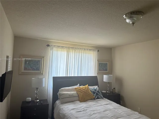 a bedroom with a bed and a mirror