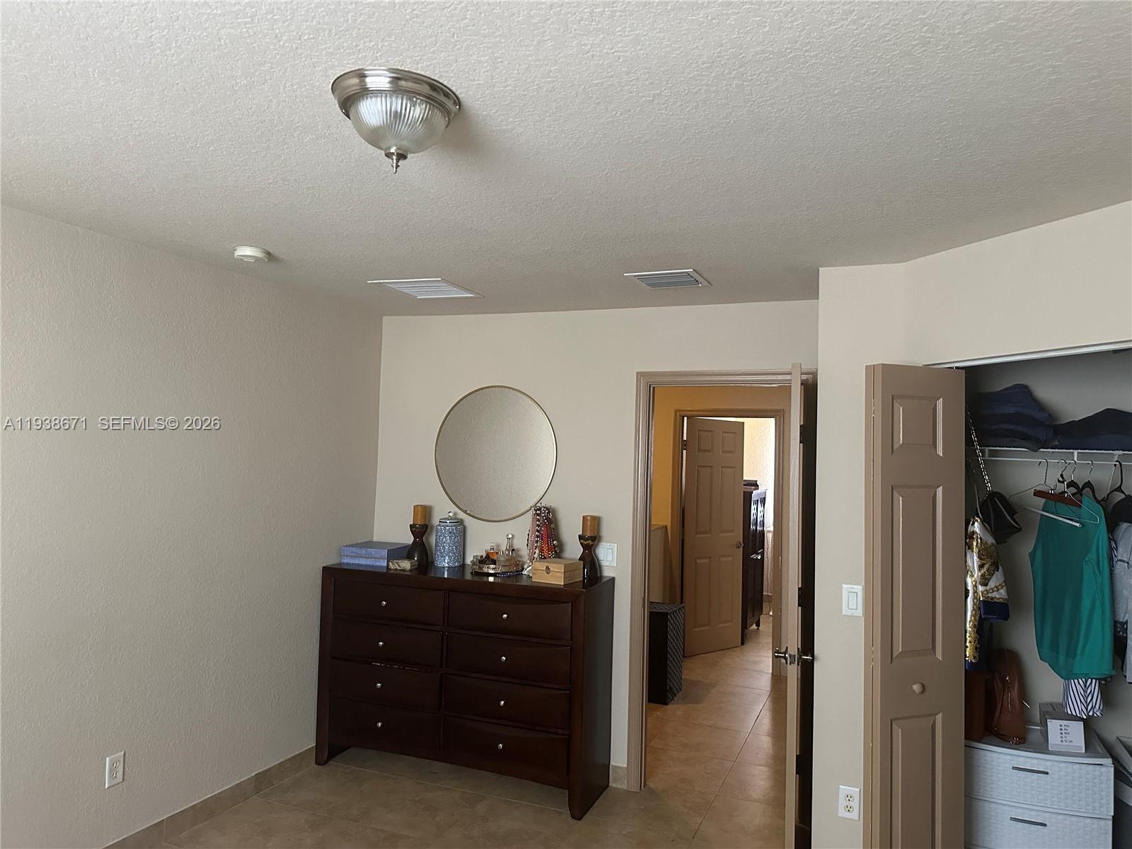 5954 Royal Way Tamarac, FL 33321 - Photo 19 of 28 a bedroom with a bed and a mirror