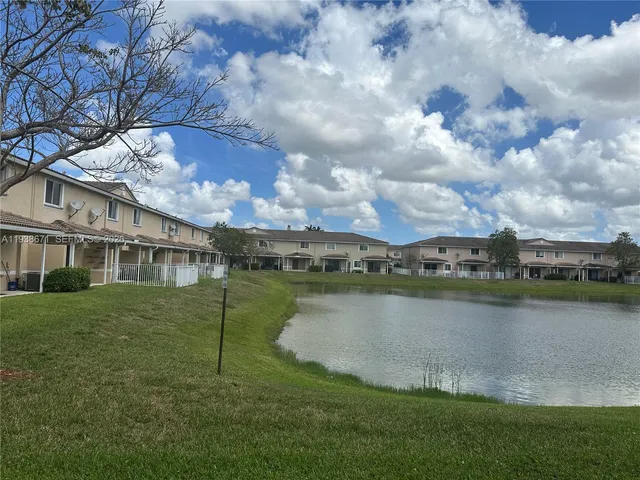 a view of a lake with a house in the background