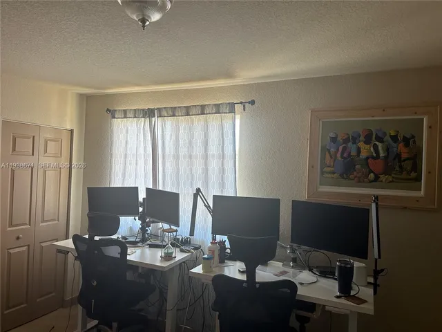 a view of a workspace with furniture and cabinet