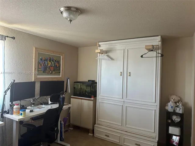 an empty room with closet and a bathroom