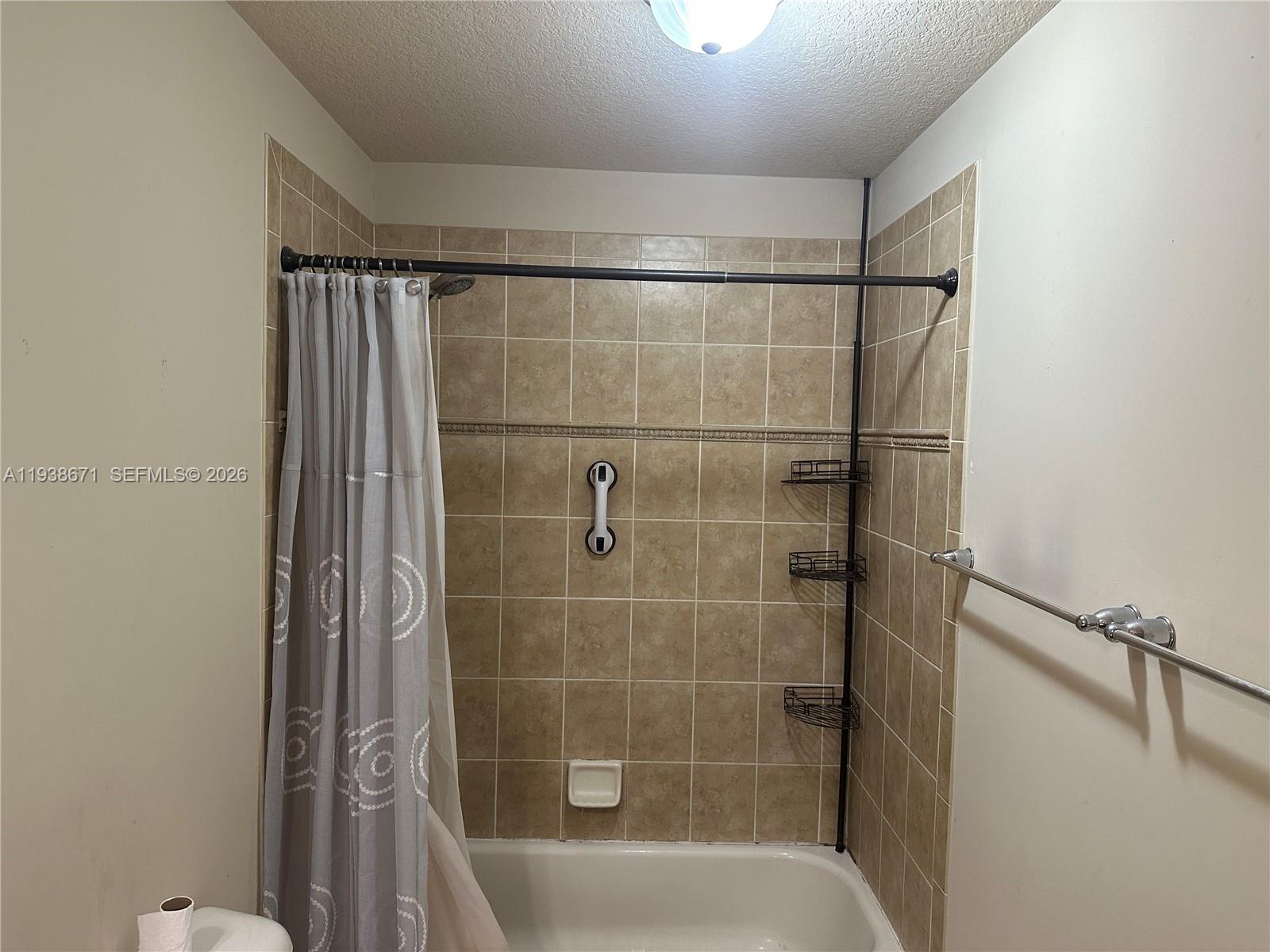 5954 Royal Way Tamarac, FL 33321 - Photo 24 of 28 a bathroom with a shower and a bathtub