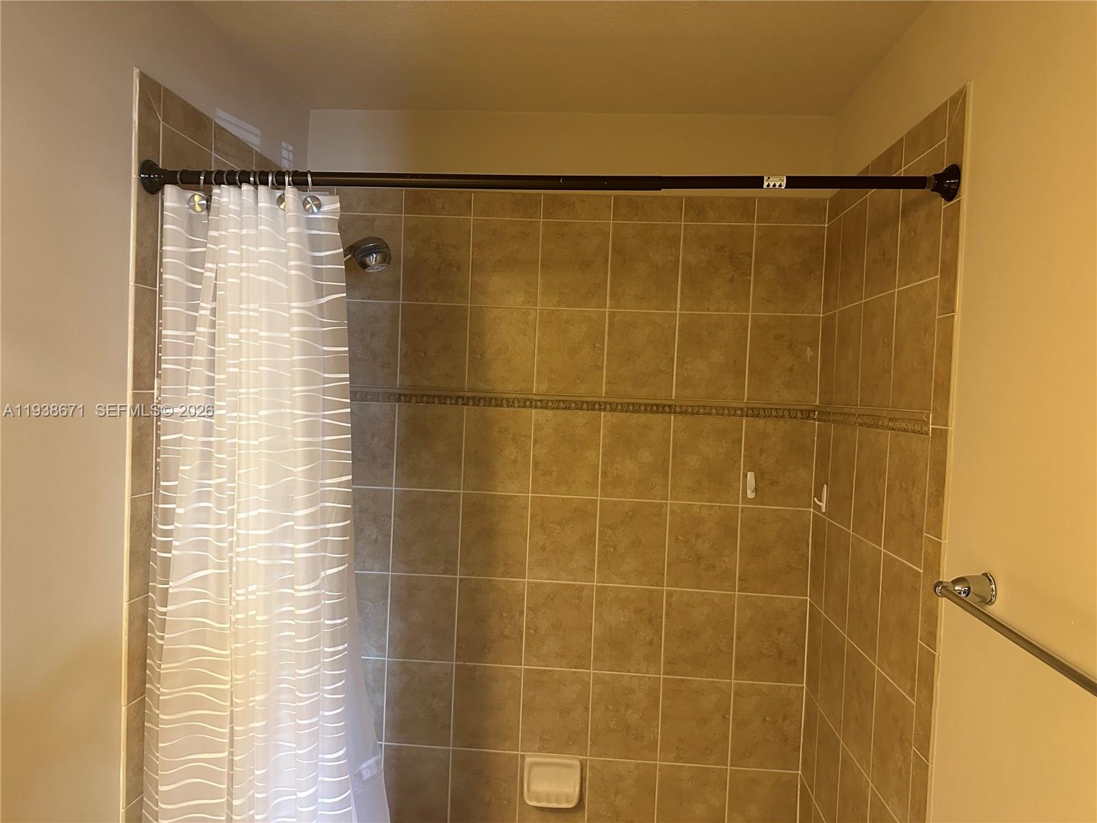 5954 Royal Way Tamarac, FL 33321 - Photo 25 of 28 a bathroom that has a shower