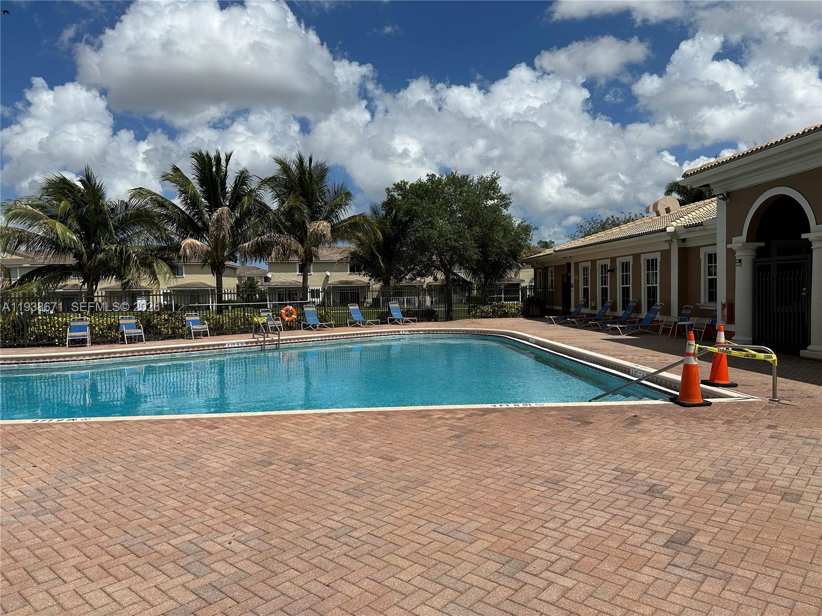 5954 Royal Way Tamarac, FL 33321 - Photo 27 of 28 a view of swimming pool with outdoor seating and covered with trees