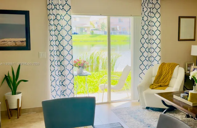 a living room with furniture rug and window