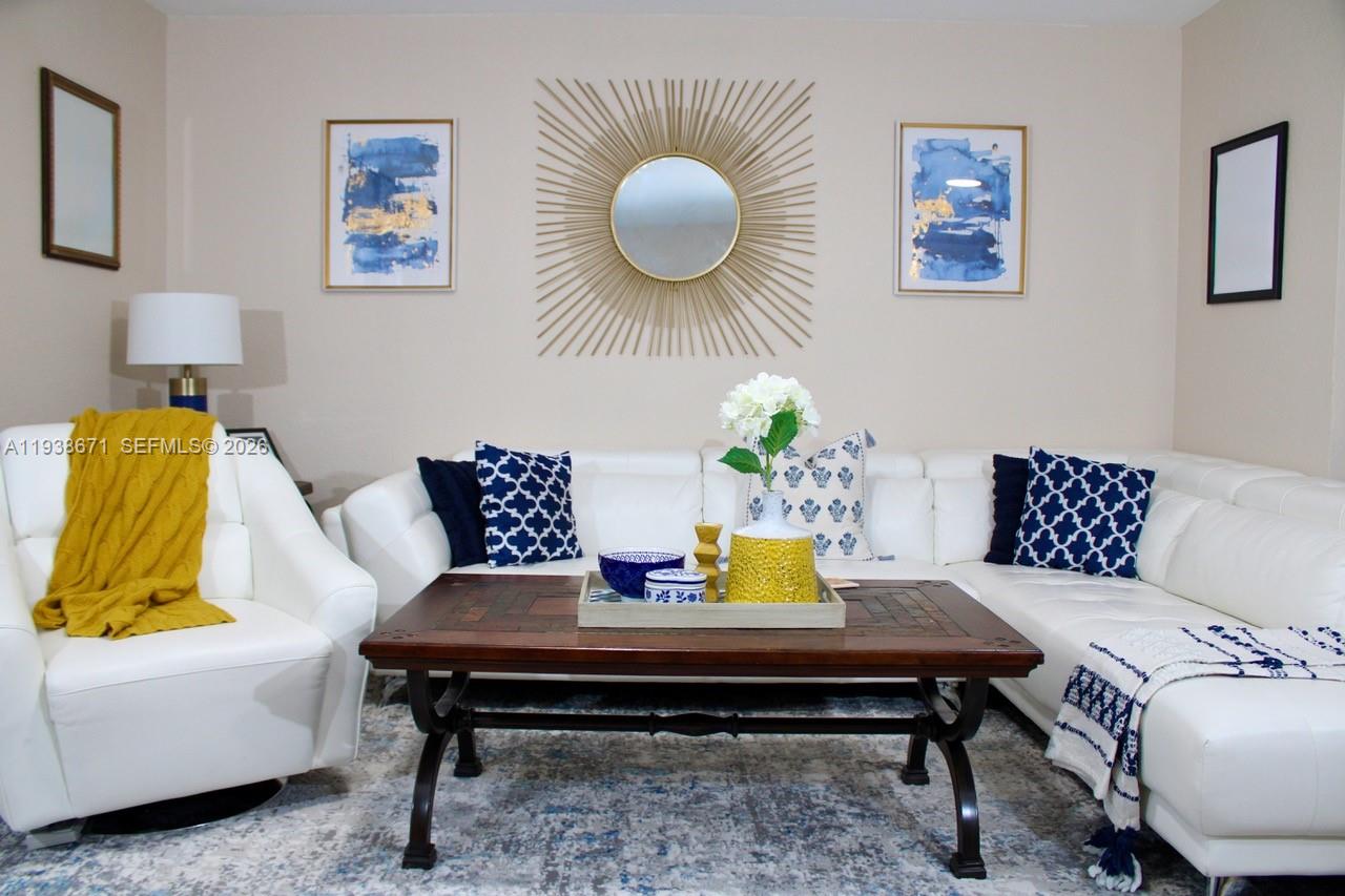 5954 Royal Way Tamarac, FL 33321 - Photo 7 of 28 a living room with furniture and wooden floor