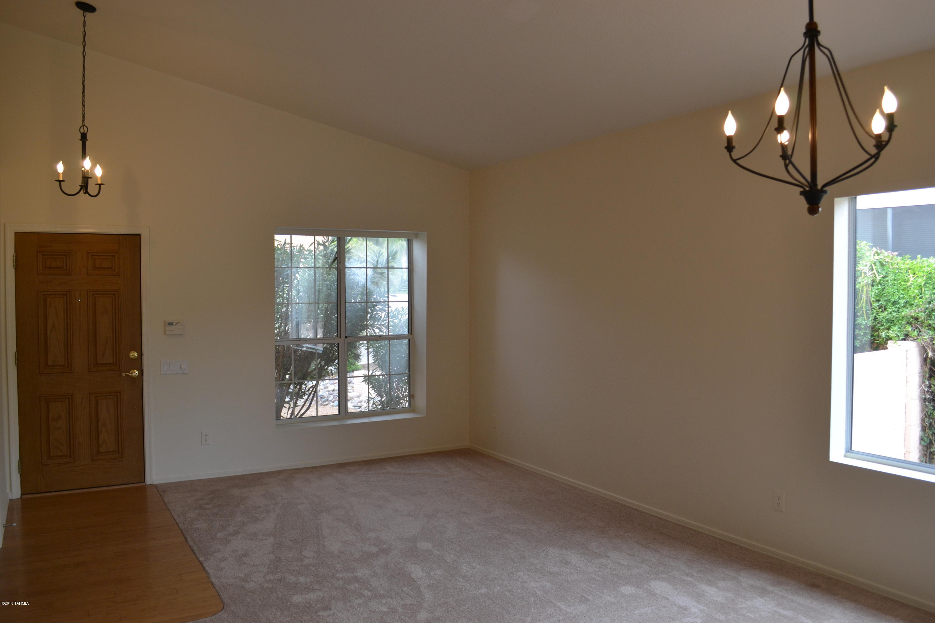5640 North Cherokee Ridge Road Tucson, AZ 85750 - Photo 3 of 39 wooden floor in an empty room with a window