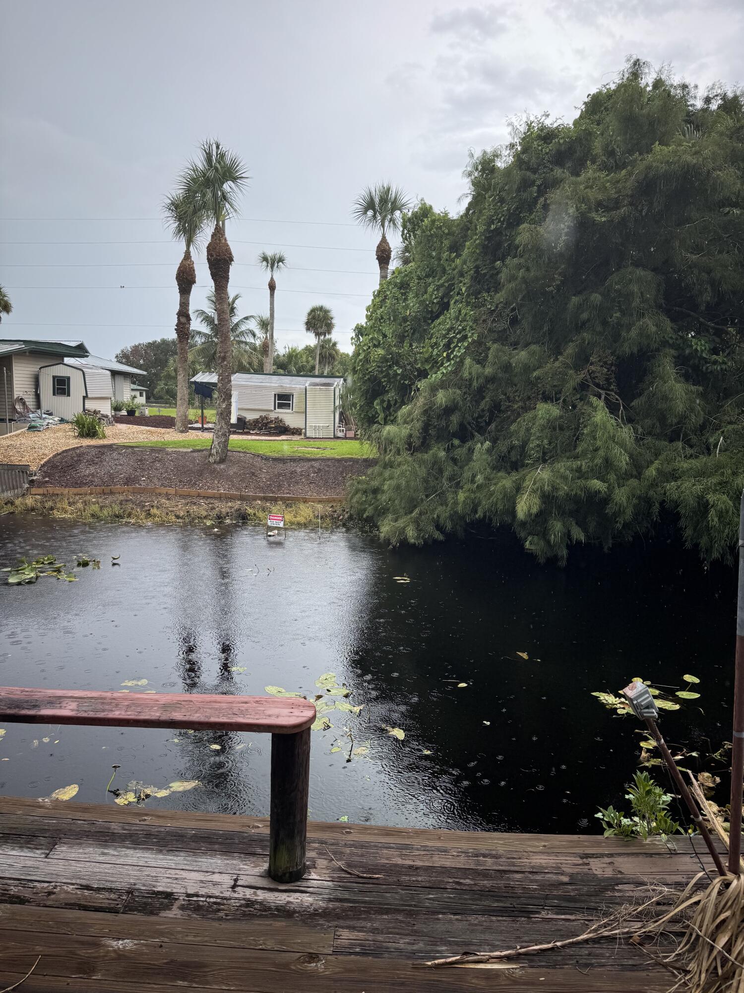 9636 Southwest Adams Avenue Okeechobee, FL 34974 - Photo 23 of 38 a view of swimming pool with a yard and lake view