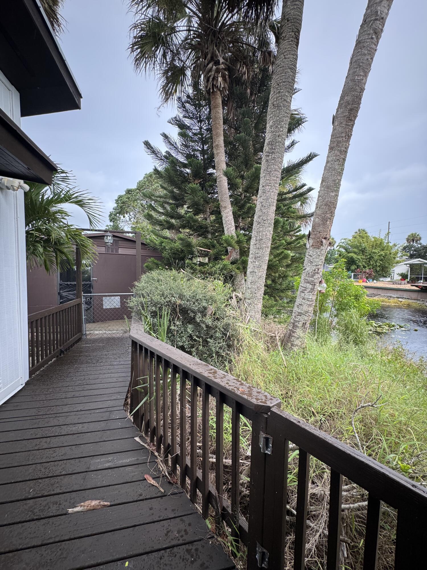 9636 Southwest Adams Avenue Okeechobee, FL 34974 - Photo 25 of 38 a balcony with wooden floor and outdoor space