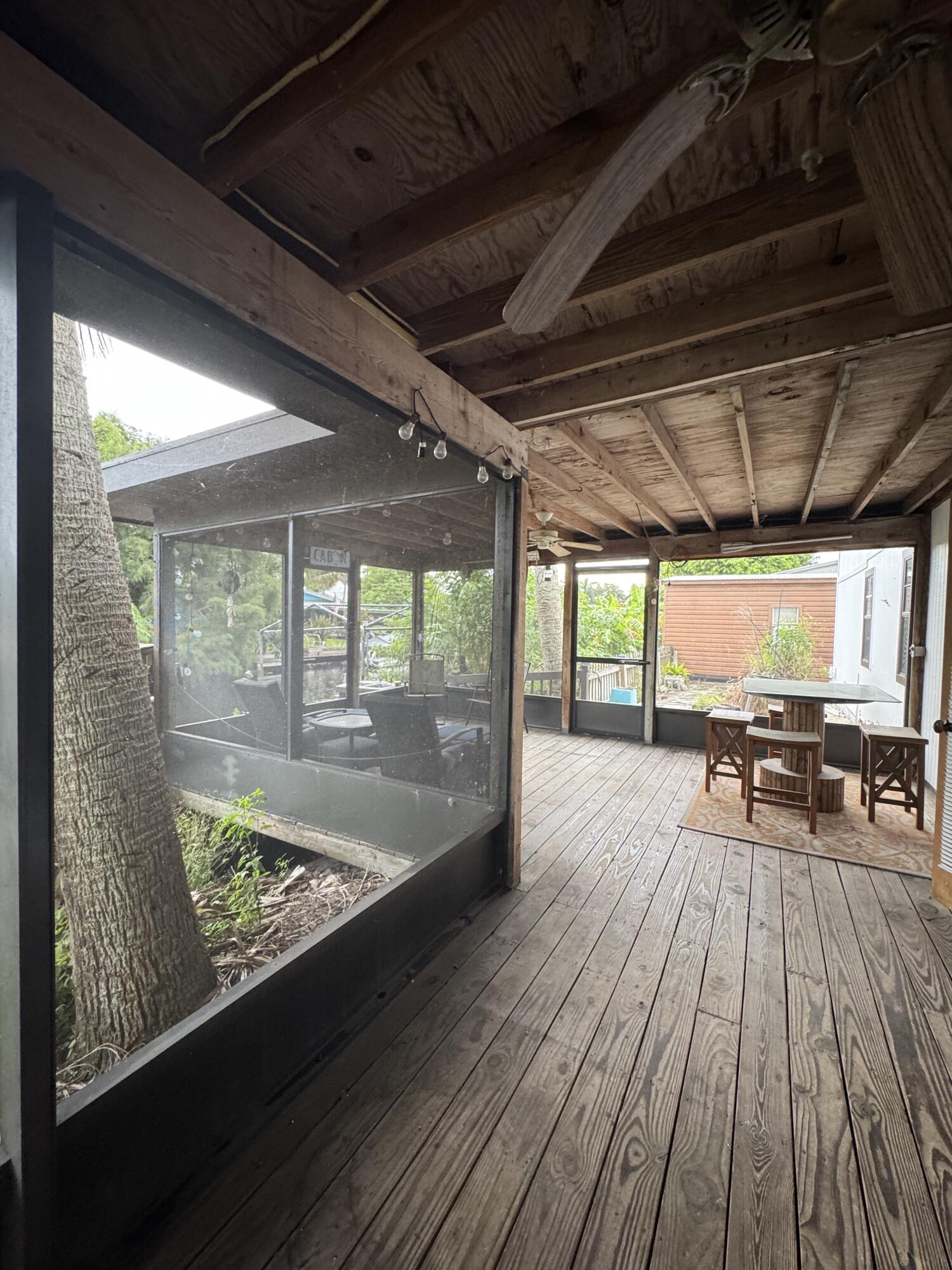 9636 Southwest Adams Avenue Okeechobee, FL 34974 - Photo 26 of 38 a view of outdoor space with wooden floor and outdoor seating