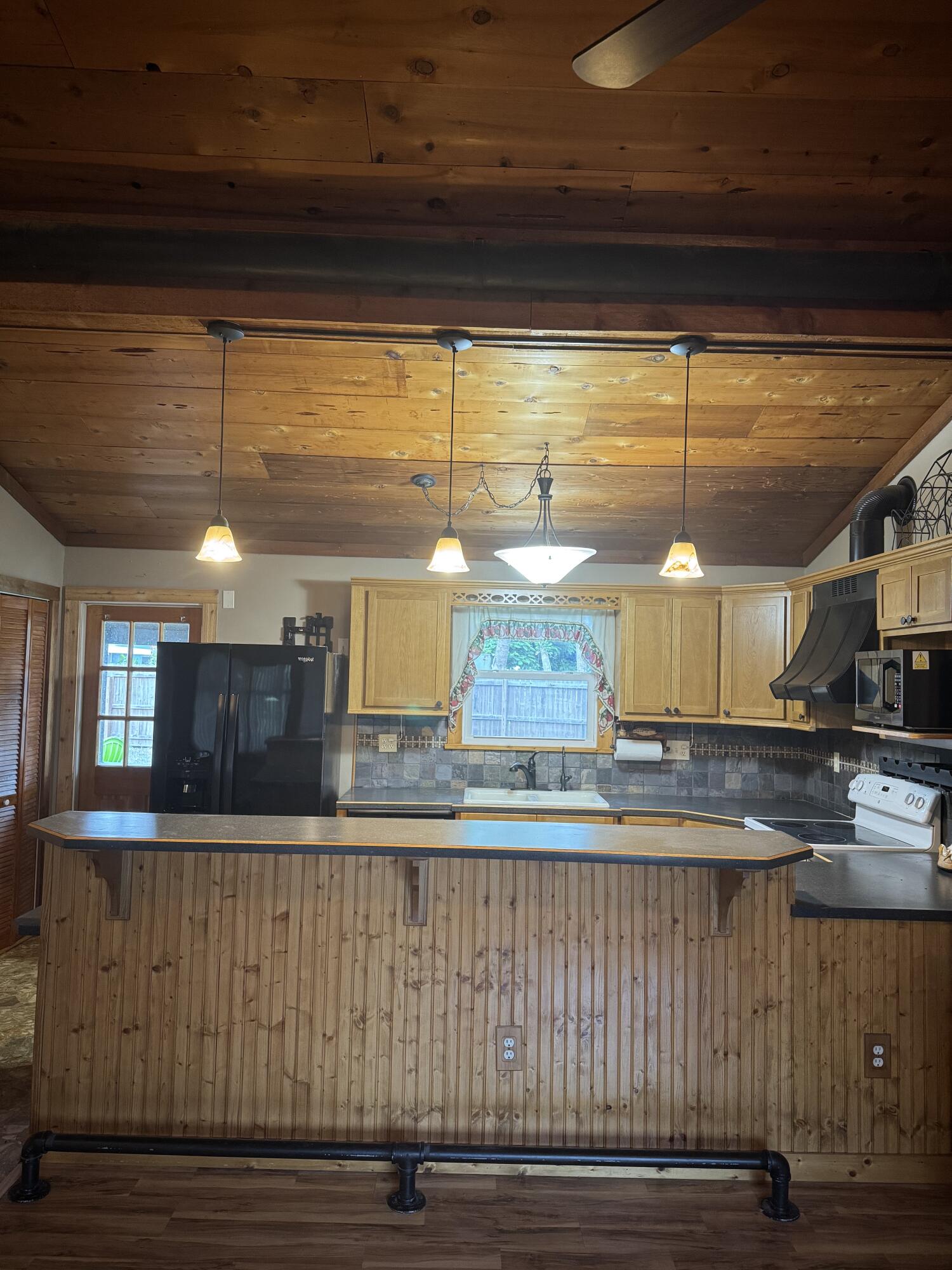9636 Southwest Adams Avenue Okeechobee, FL 34974 - Photo 30 of 38 a kitchen with a table and chairs in it