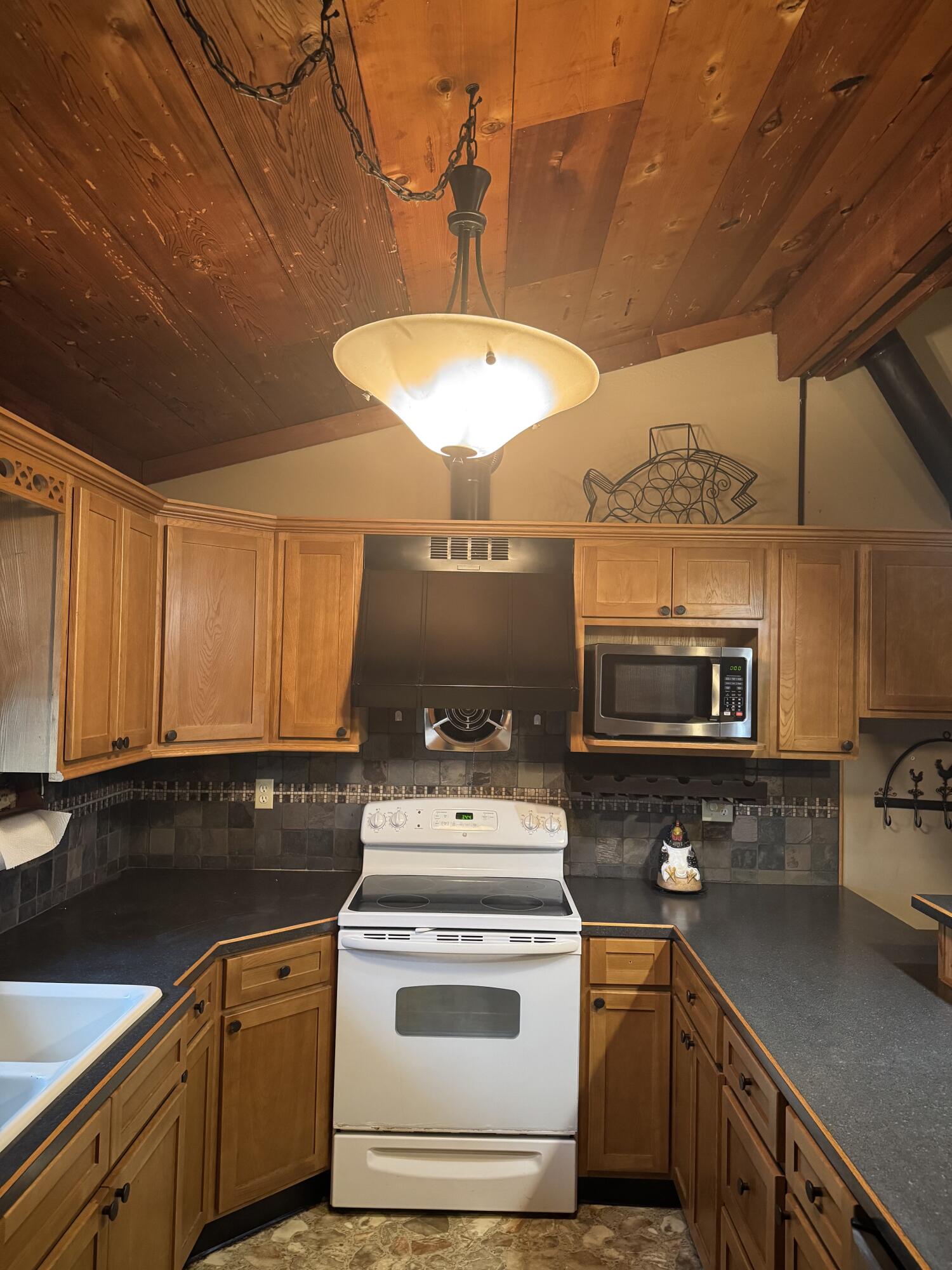 9636 Southwest Adams Avenue Okeechobee, FL 34974 - Photo 7 of 38 a kitchen with a stove and a microwave