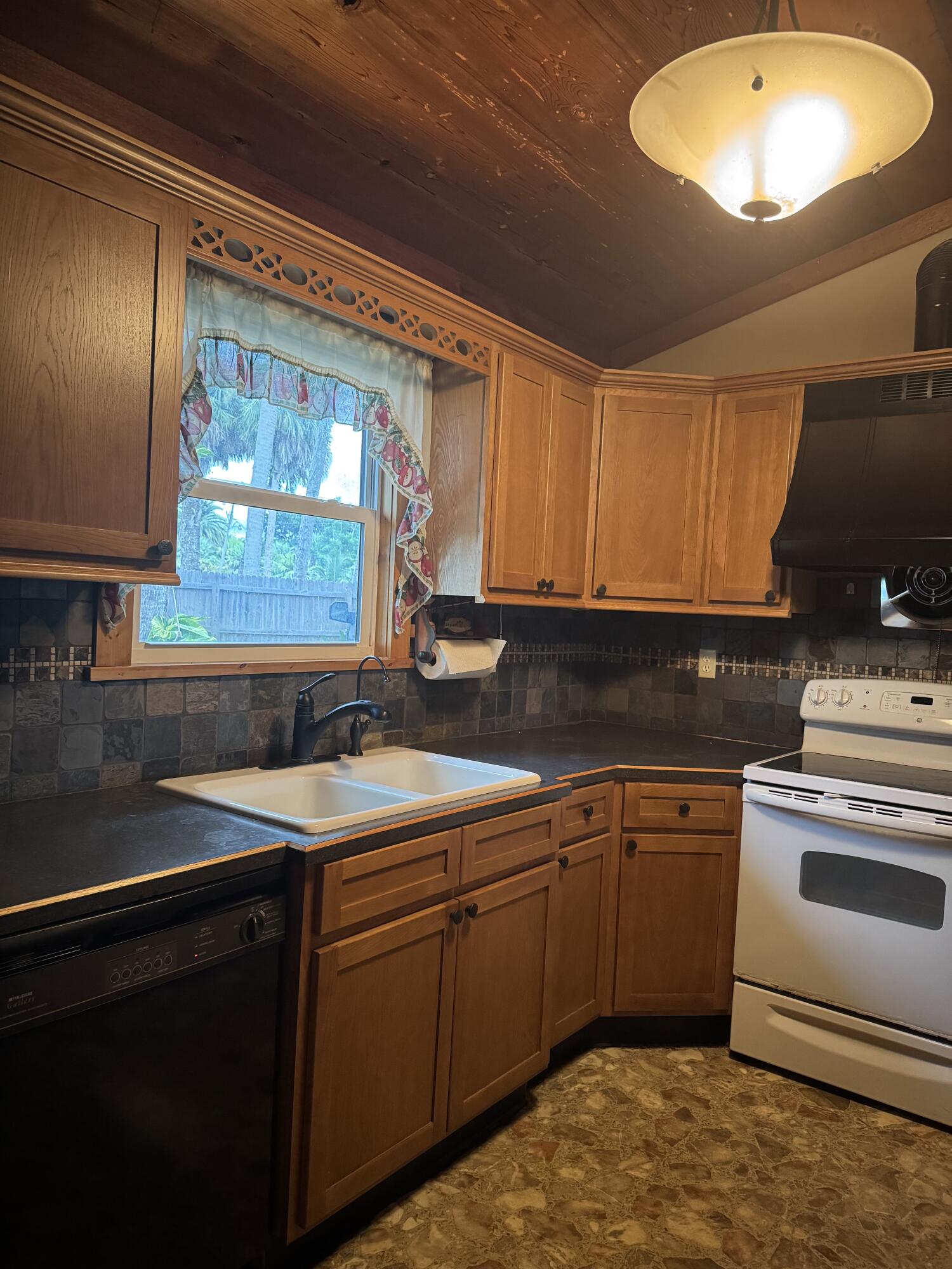 9636 Southwest Adams Avenue Okeechobee, FL 34974 - Photo 8 of 38 a kitchen with a sink stove and cabinets