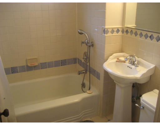 38 Robbins Road Arlington, MA 02476 - Photo 12 of 16 a bathroom with a sink a mirror and a bathtub