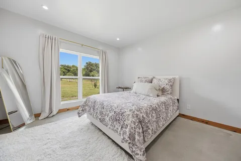 a bed sitting in a bedroom next to a window