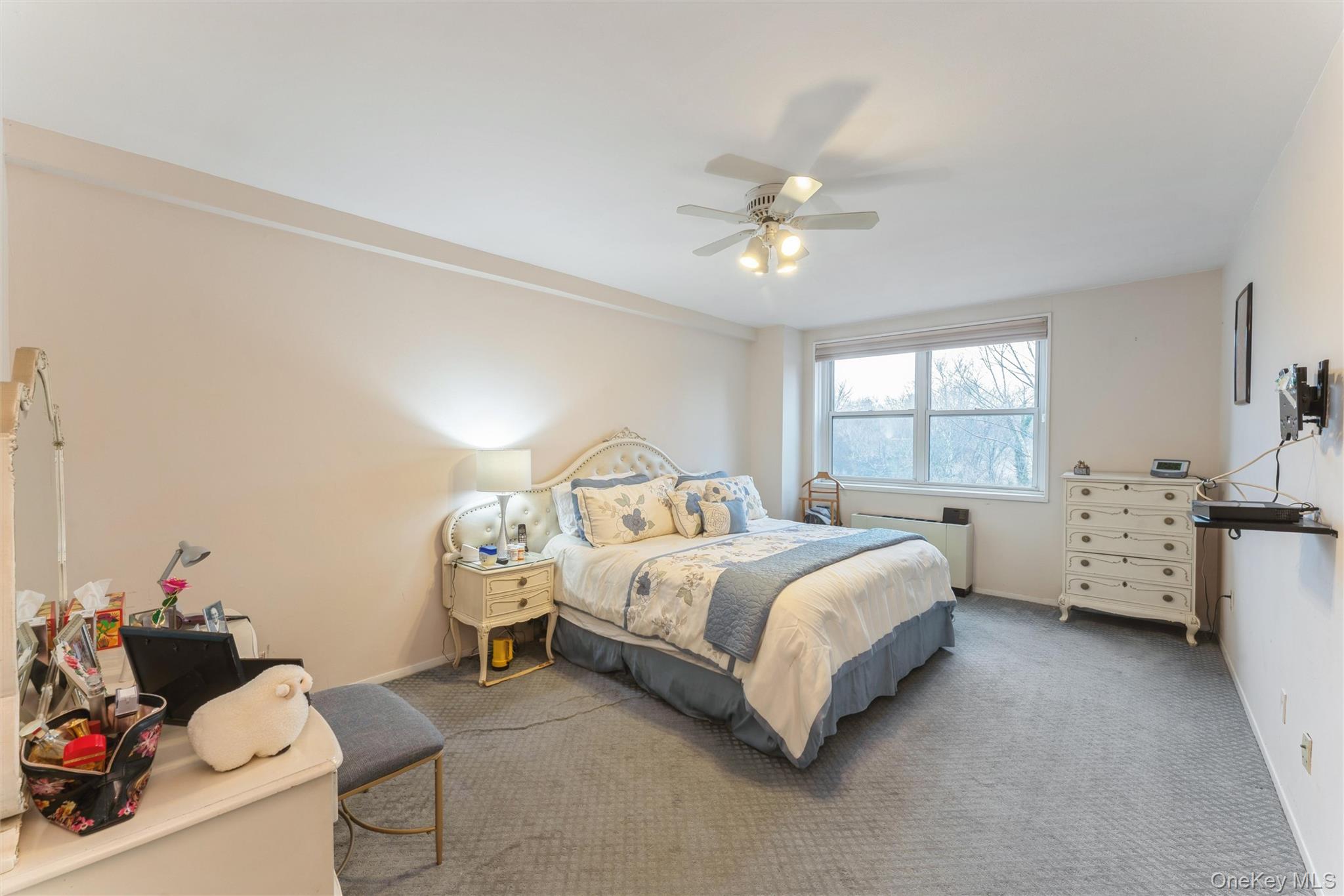 1 Kensington Gate, Unit PH9 Great Neck, NY 11021 - Photo 11 of 17 a bed room with a bed and a chandelier