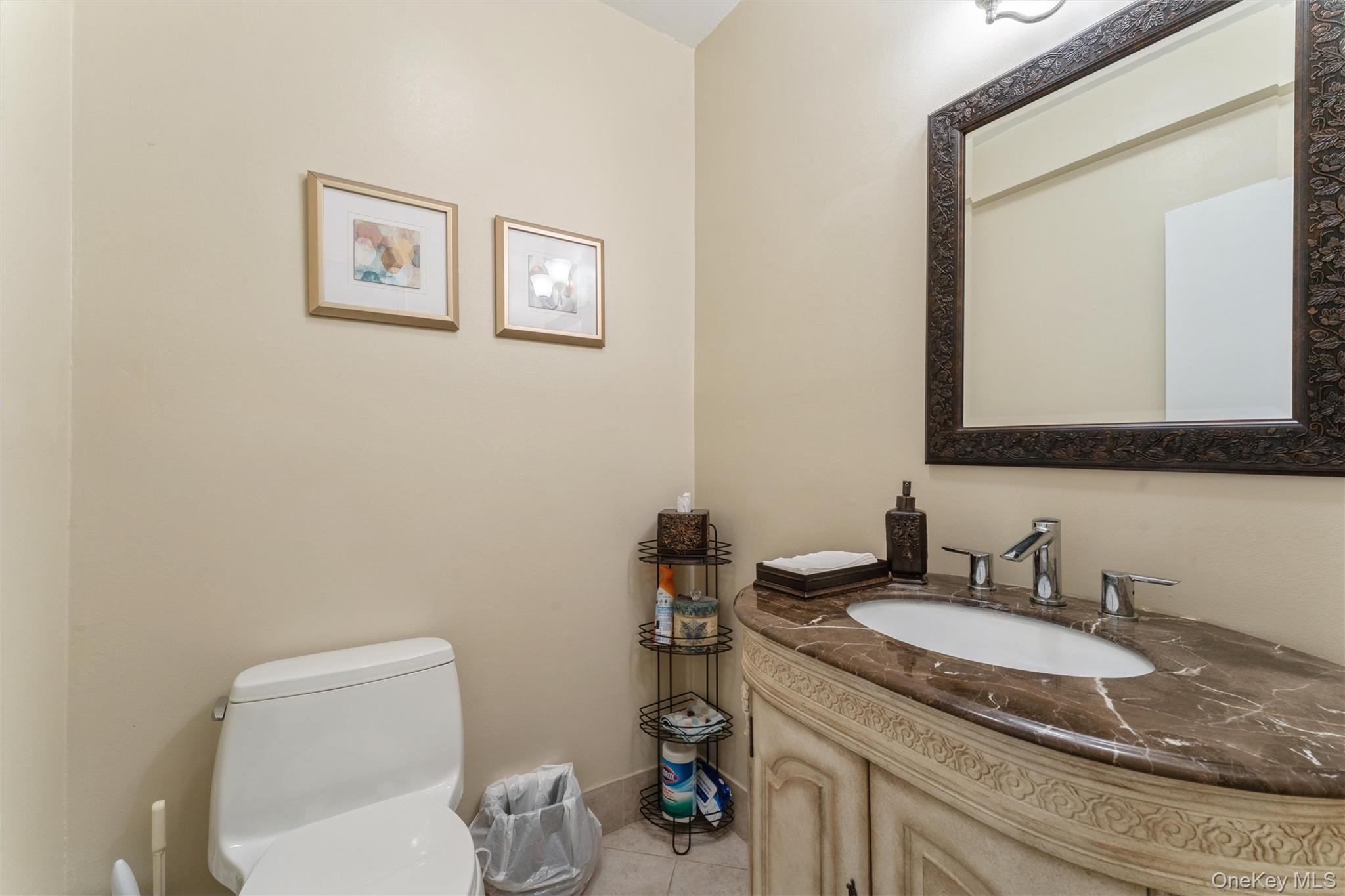 1 Kensington Gate, Unit PH9 Great Neck, NY 11021 - Photo 12 of 17 a bathroom with a granite countertop toilet sink and mirror