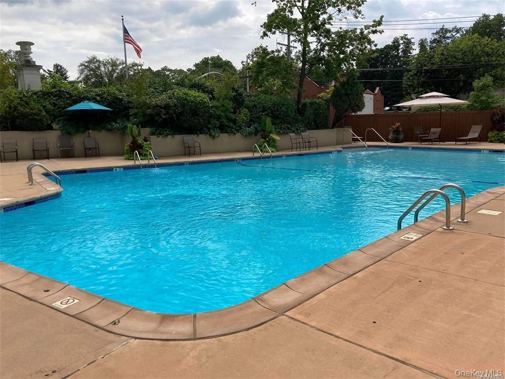 1 Kensington Gate, Unit PH9 Great Neck, NY 11021 - Photo 13 of 17 a view of a swimming pool with a yard and plants