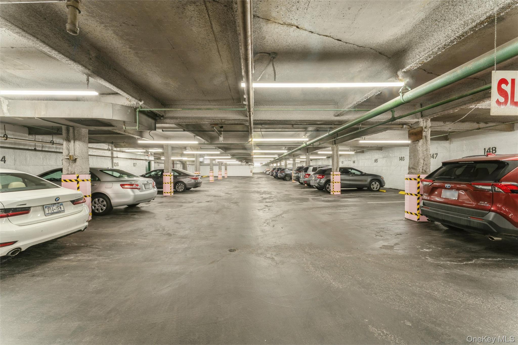 1 Kensington Gate, Unit PH9 Great Neck, NY 11021 - Photo 15 of 17 a view of cars parked in a parking