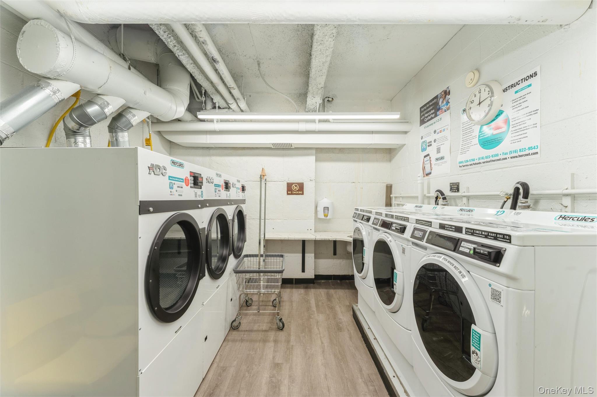 1 Kensington Gate, Unit PH9 Great Neck, NY 11021 - Photo 16 of 17 a utility room with dryer and washer