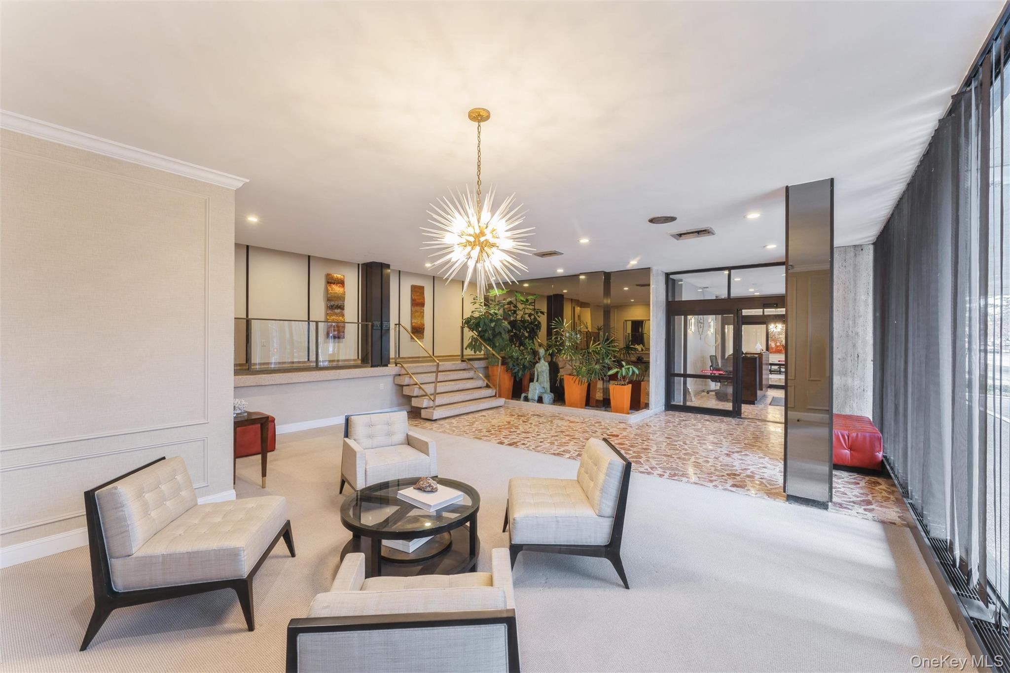 1 Kensington Gate, Unit PH9 Great Neck, NY 11021 - Photo 3 of 17 a living room with furniture a chandelier a fireplace and a chandelier