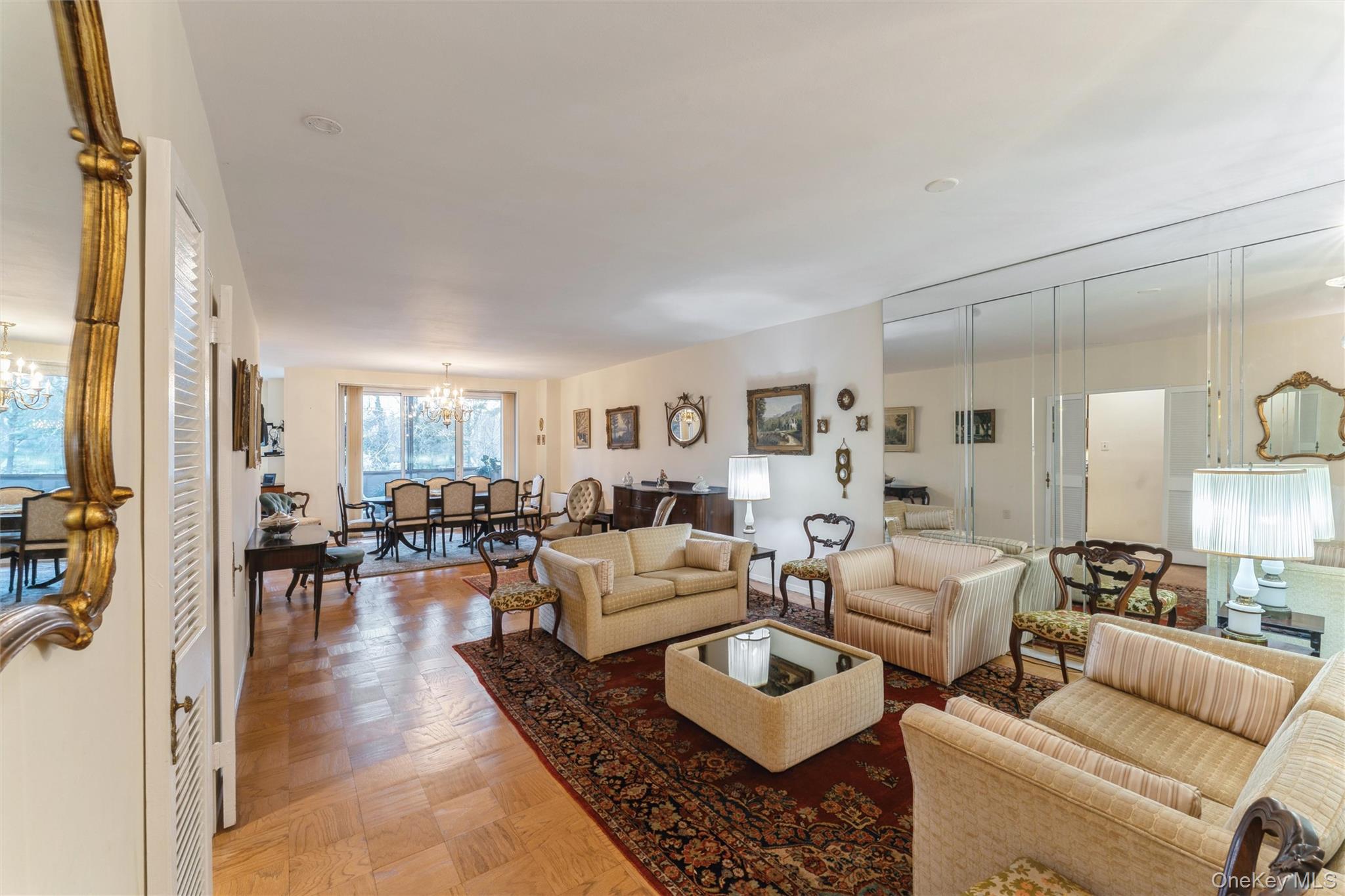 1 Kensington Gate, Unit PH9 Great Neck, NY 11021 - Photo 5 of 17 a living room with furniture and a large window